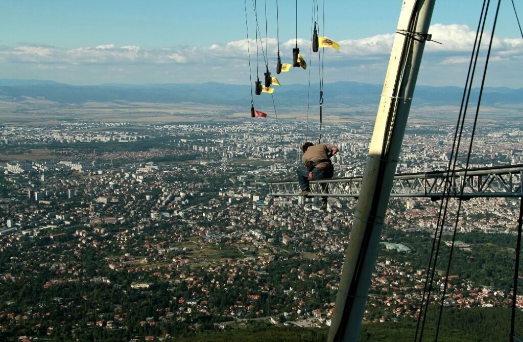 One Try Productions operator - Georgi Vasilev setting up cameras on a metal construction high above a cliff for a movie shot near Sofia city.