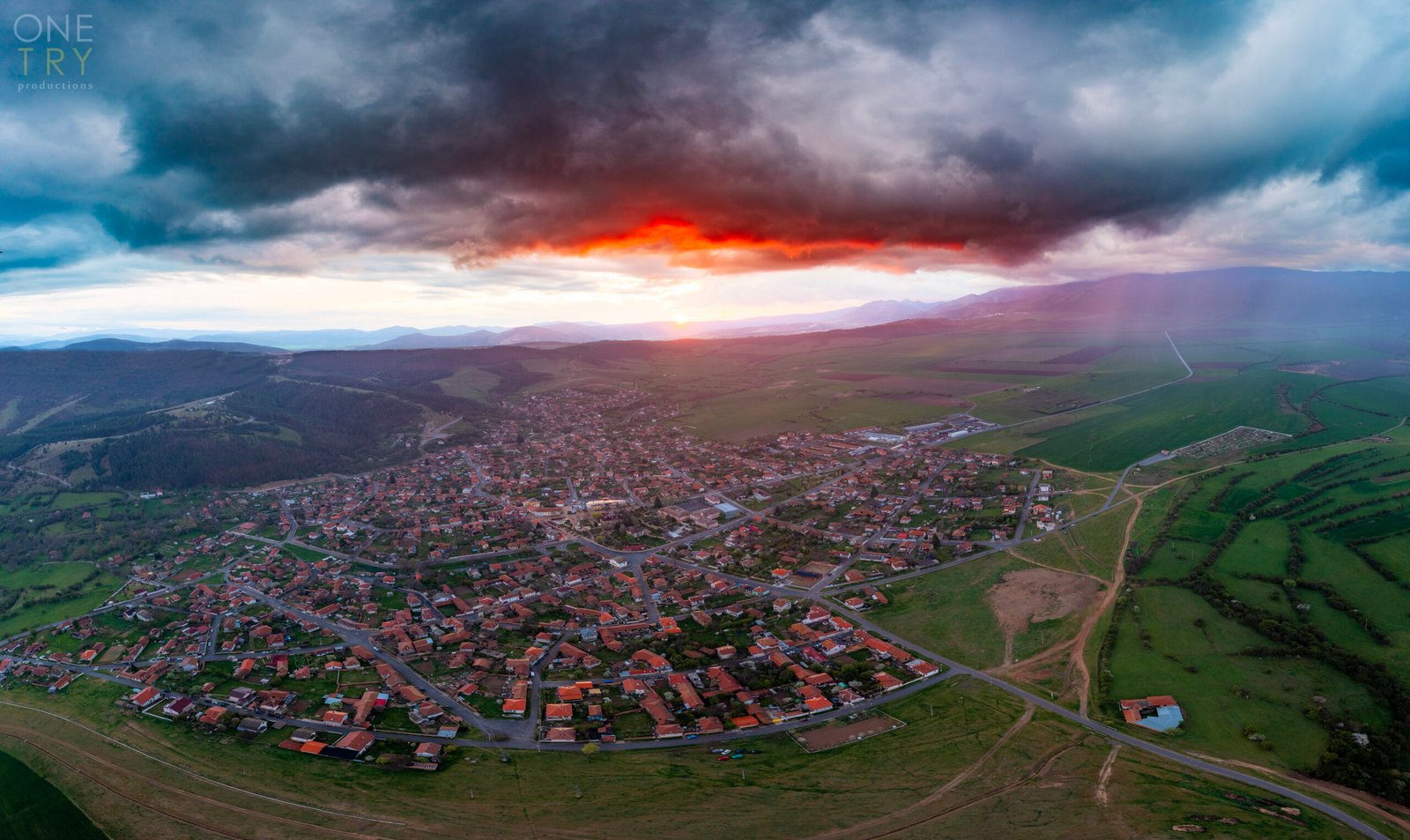 Sunrise above Chavdar with clouds and bright red colors, shot with a drone.